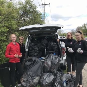 Students with garage bags